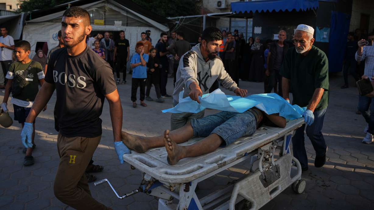 Palestinians wheel the body of a man killed in Israeli strikes on the Gaza Strip to the morgue at Al-Aqsa Hospital in Deir al-Balah on Saturday.