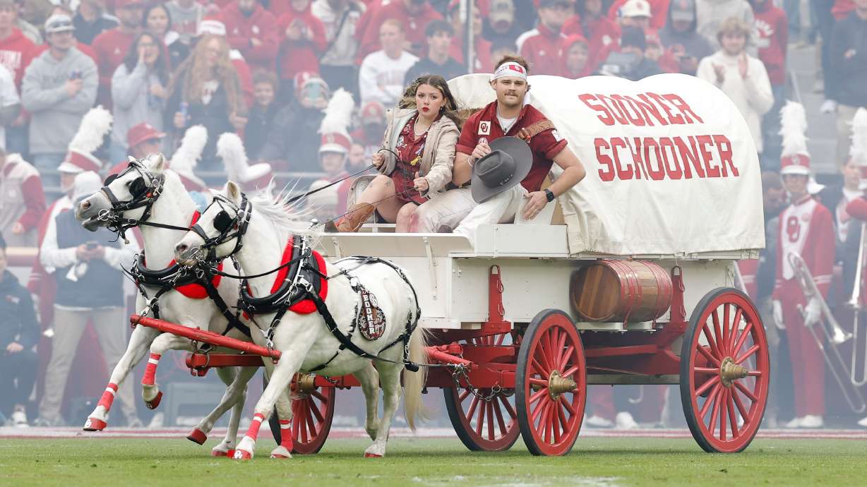 Members of the Oklahoma spirit groups drive the Sooner Schooner after a touchdown against Missouri during the first half of an NCAA college football game Saturday, Nov. 22, 2025, in Norman, Okla.