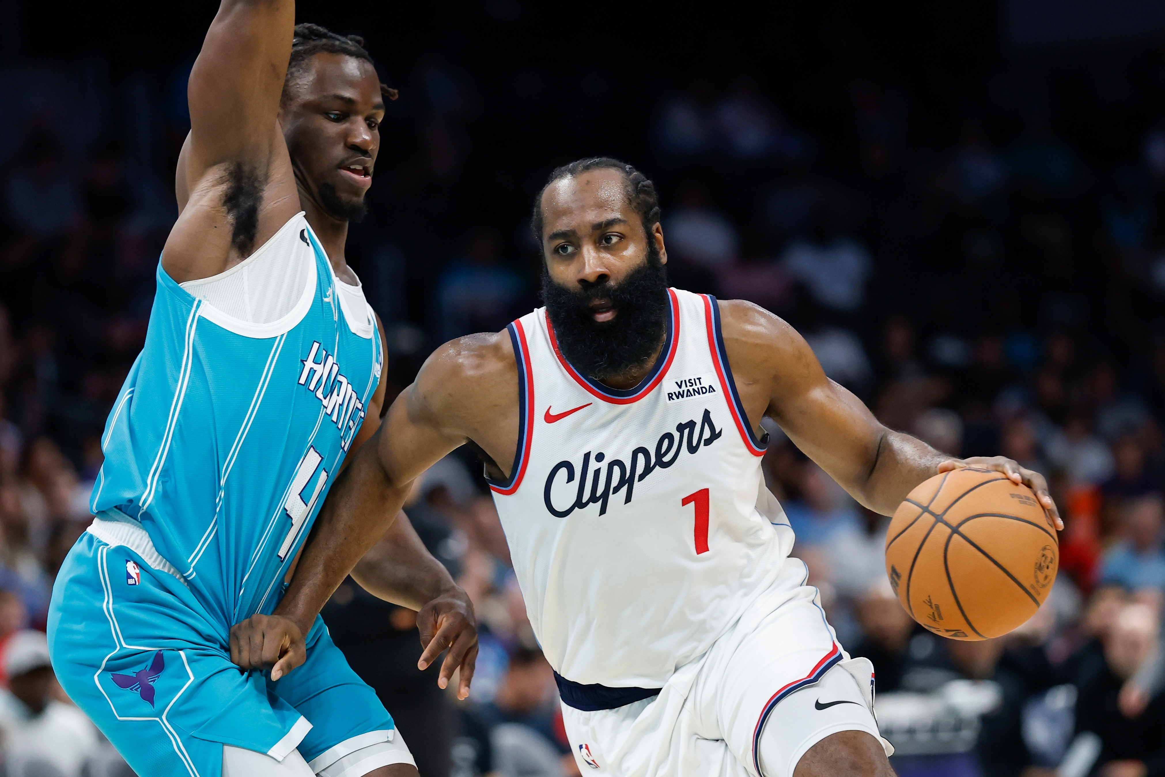 Los Angeles Clippers guard James Harden, right, drives to the basket against Charlotte Hornets guard Sion James during the first half of an NBA basketball game in Charlotte, N.C., Saturday, Nov. 22, 2025. 