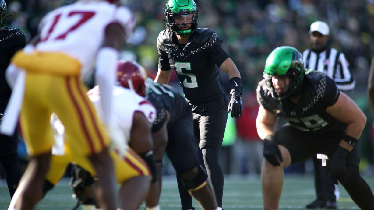 Oregon quarterback Dante Moore (5) calls instructions during the first half of an NCAA college football game against Southern California, Saturday, Nov. 22, 2025, in Eugene, Ore.