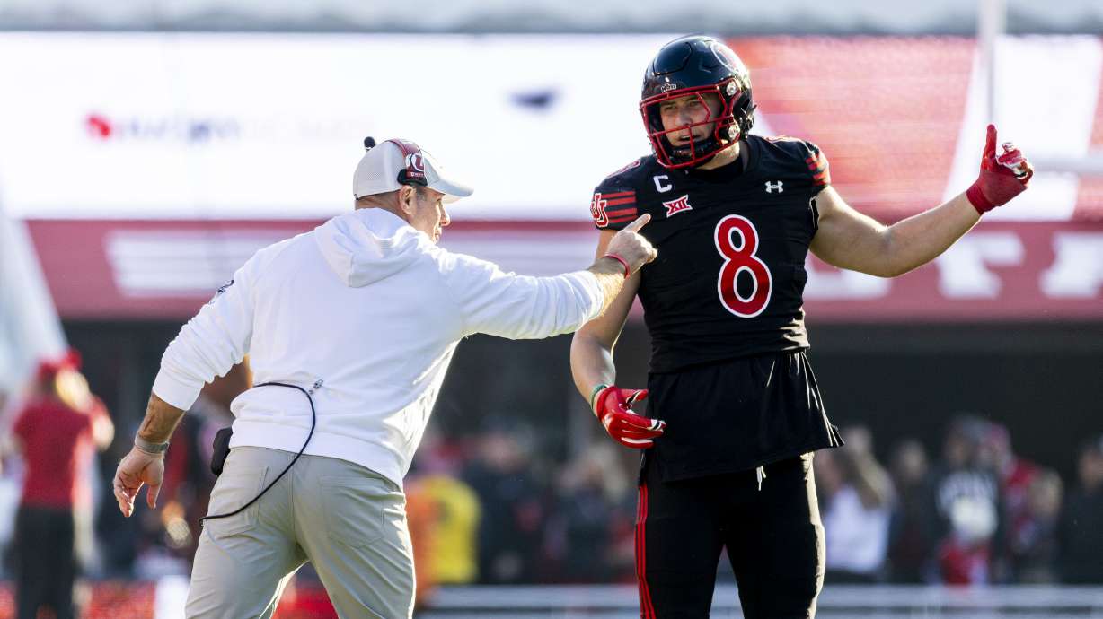 Utah defensive coordinator Morgan Scalley talks with linebacker Lander Barton (8) before a play against the Kansas State Wildcats during an NCAA football game held at Rice-Eccles Stadium in Salt Lake City on Saturday, Nov. 22, 2025.