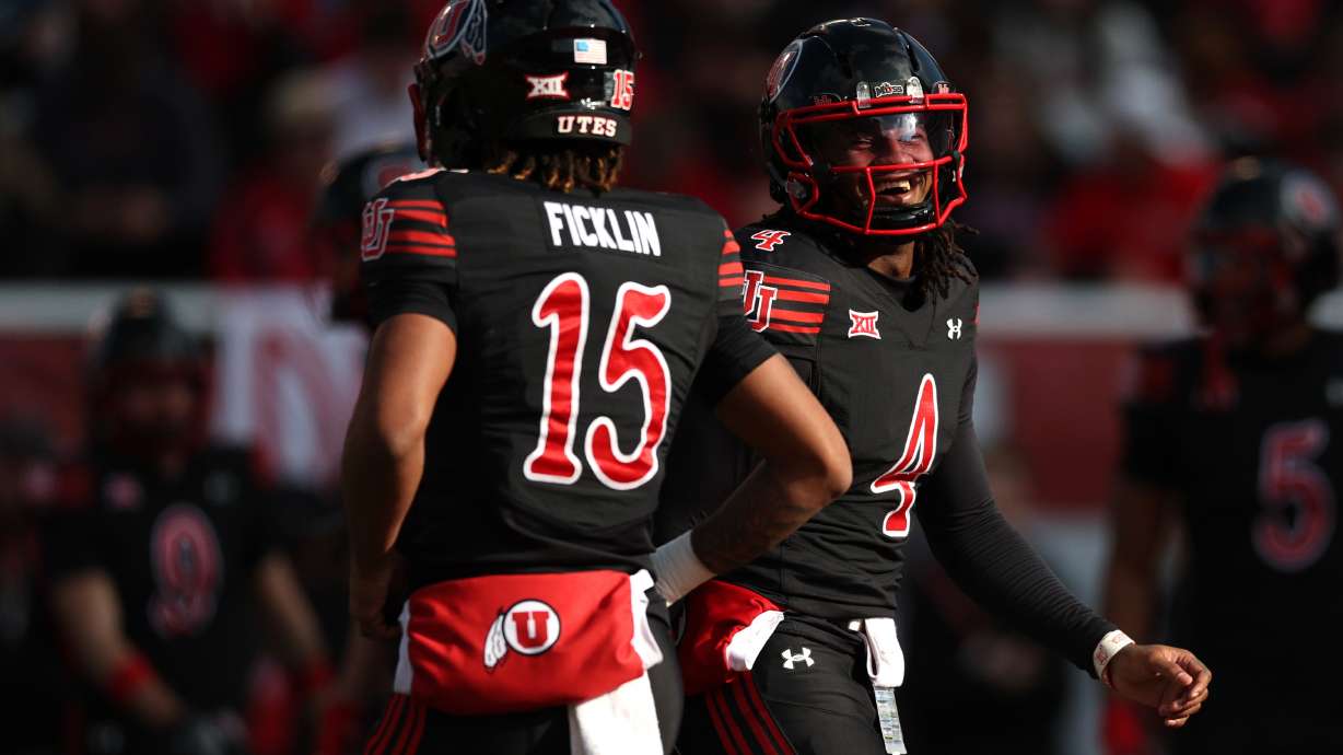 Utah quarterbacks Devon Dampier (4) and Byrd Ficklin (15) look on during warmups before an NCAA football game against the Kansas State Wildcats held at Rice-Eccles Stadium in Salt Lake City on Saturday, Nov. 22, 2025.