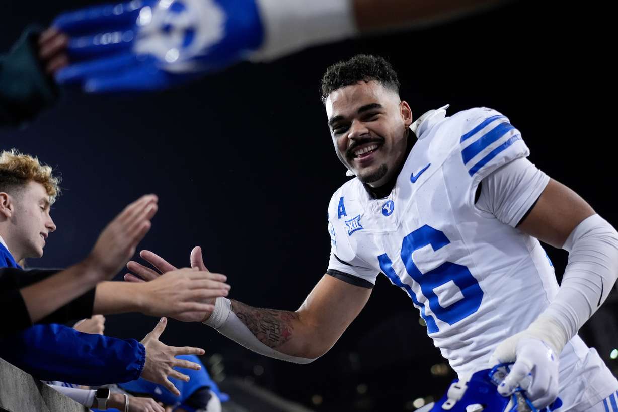 BYU linebacker Isaiah Glasker (16) celebrates with fans after winning an NCAA college football game against Cincinnati, Saturday, Nov. 22, 2025, in Cincinnati.