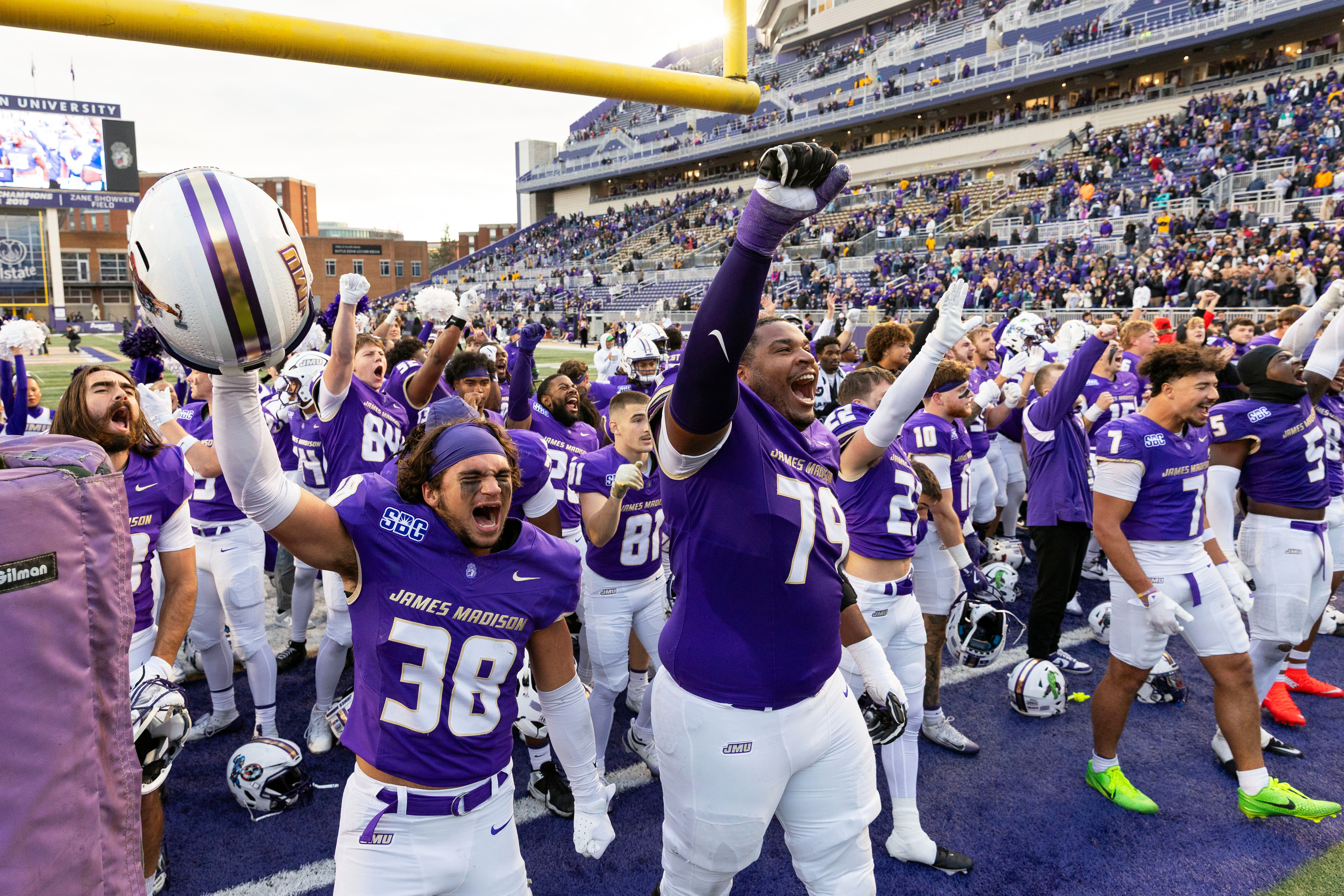 James Madison players celebrate defeating Washington State in an NCAA college football game, Saturday, Nov. 22, 2025, in Harrisonburg, Va. 