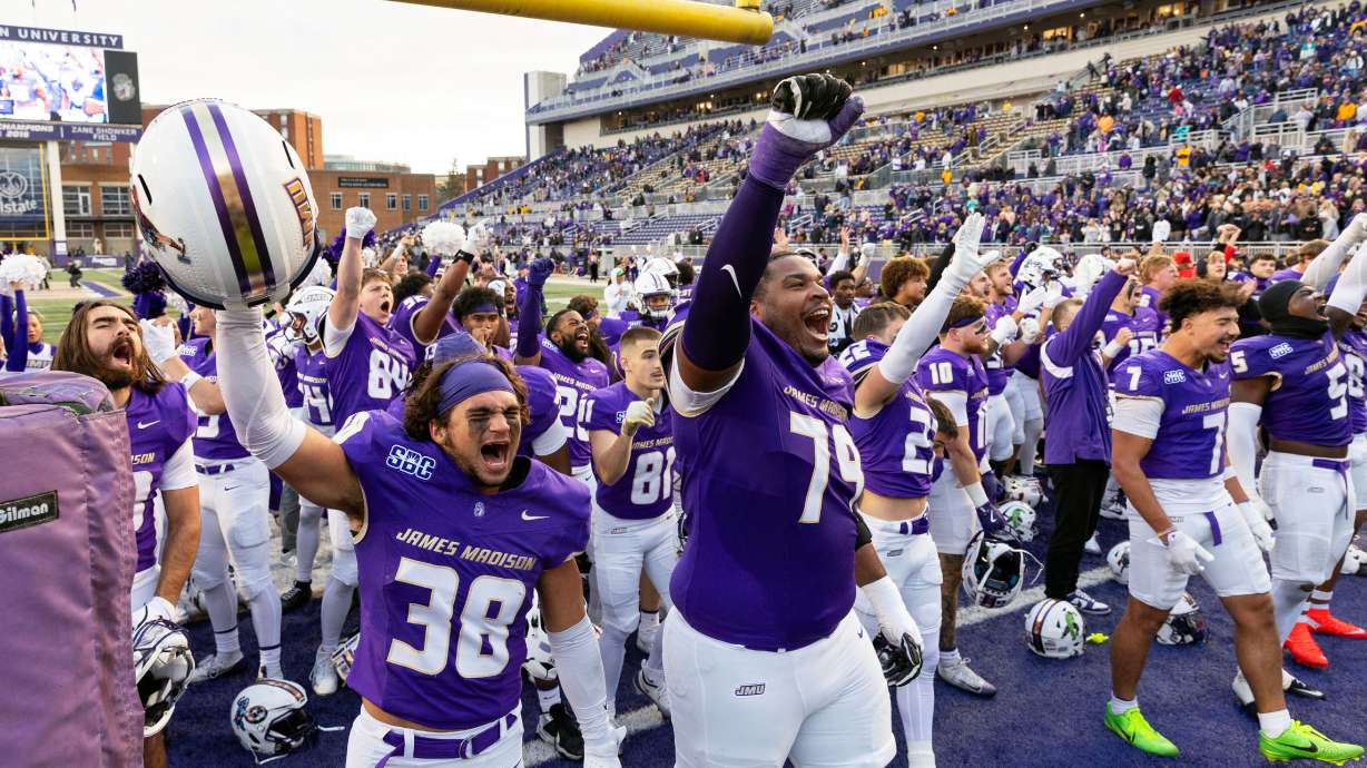 James Madison players celebrate defeating Washington State in an NCAA college football game, Saturday, Nov. 22, 2025, in Harrisonburg, Va.