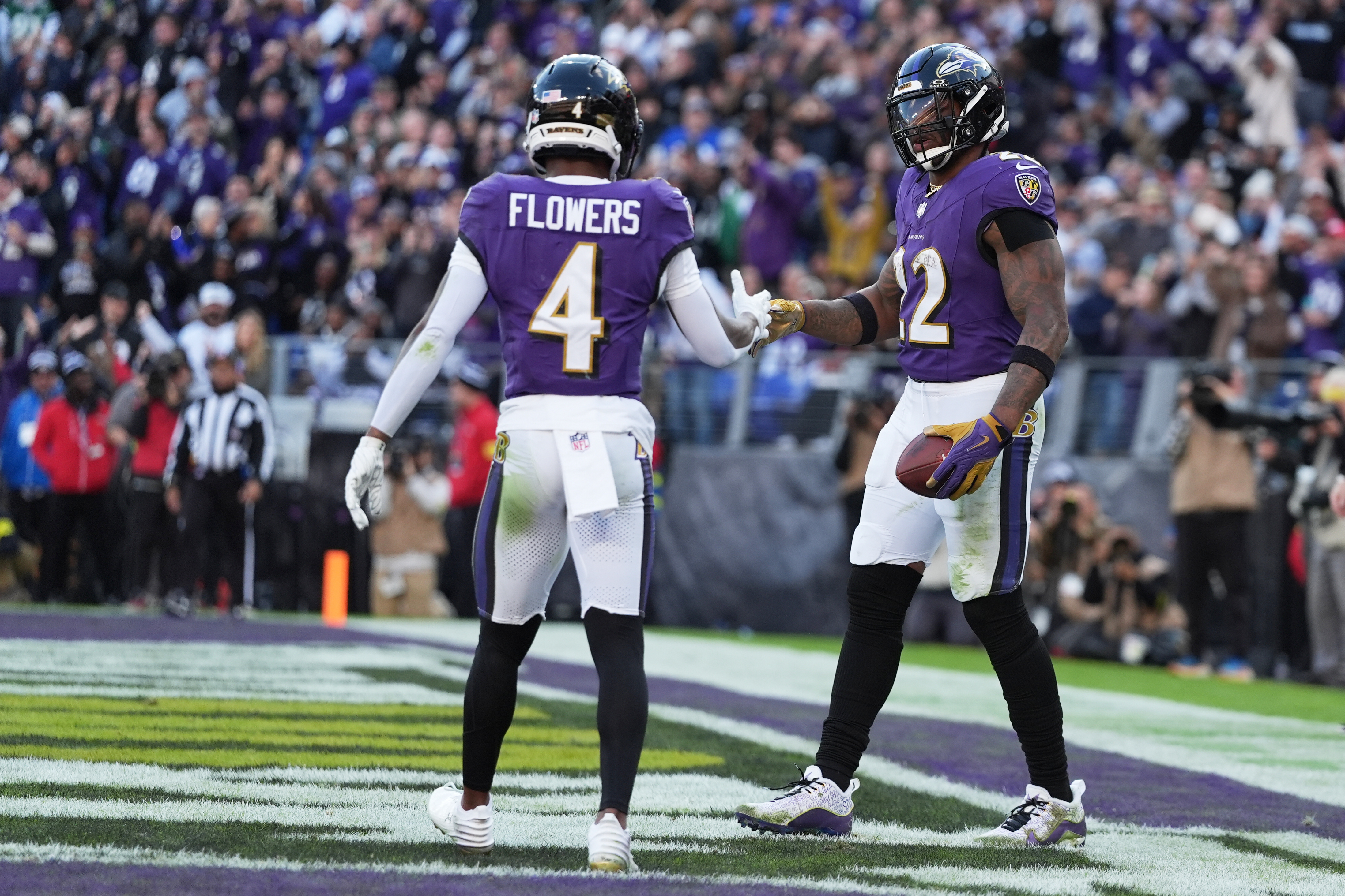 Baltimore Ravens running back Derrick Henry (22) shakes hands with wide receiver Zay Flowers (4) after scoring a touchdown during the second half of an NFL football game against the New York Jets, Sunday, Nov. 23, 2025, in Baltimore. 