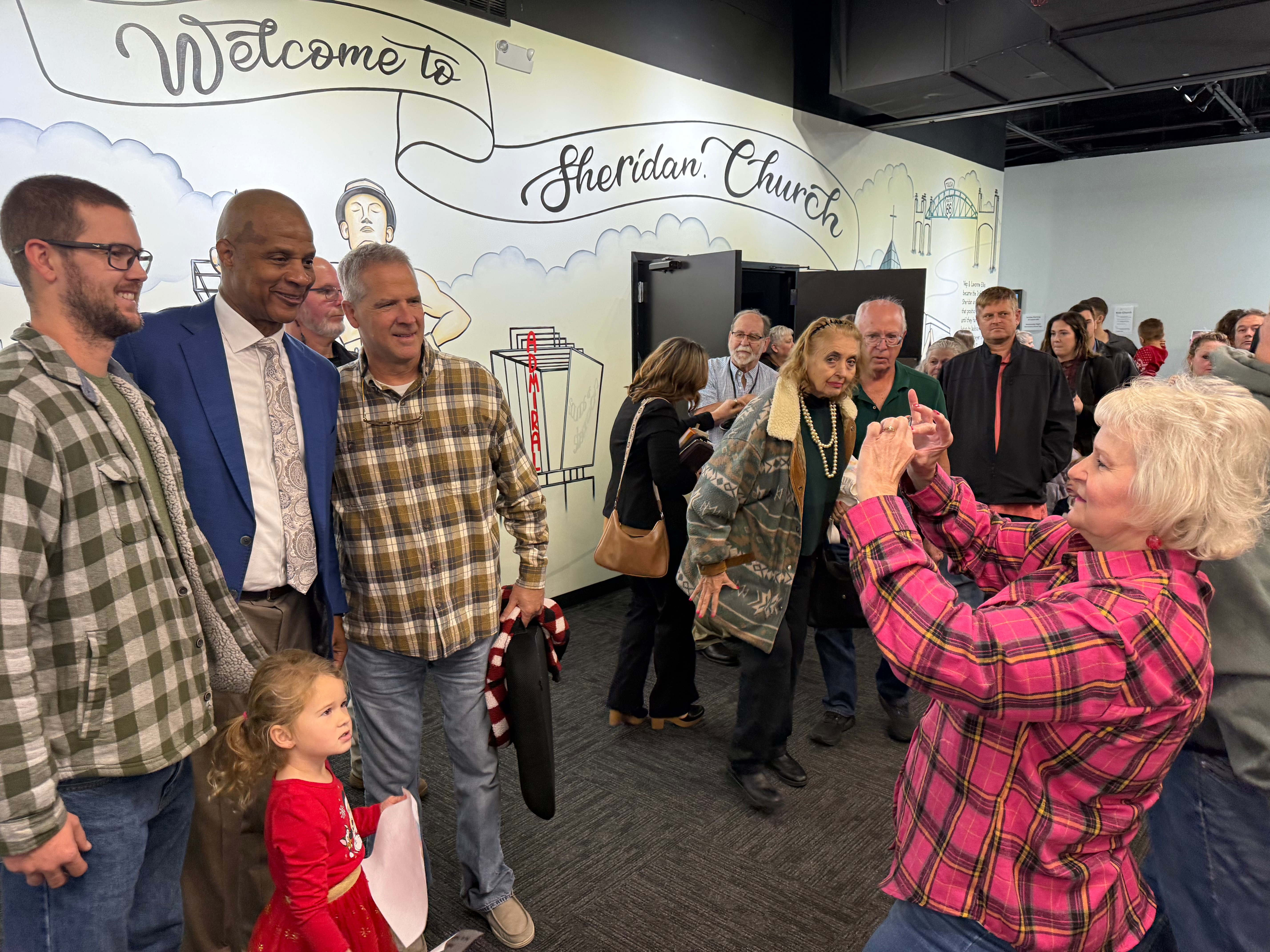Former Major League baseball player Darryl Strawberry, second from left, poses with some of the people who heard him preach on Sunday, Nov. 23, 2025, at Sheridan Church, in Tulsa, Okla.