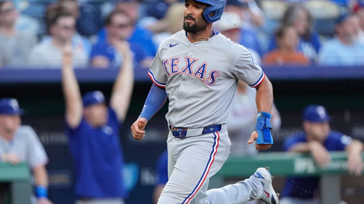 FILE - Texas Rangers' Marcus Semien runs home to score on an RBI single hit by Jonah Heim during the second inning of a baseball game against the Kansas City Royals, Monday, Aug. 18, 2025, in Kansas City, Mo.