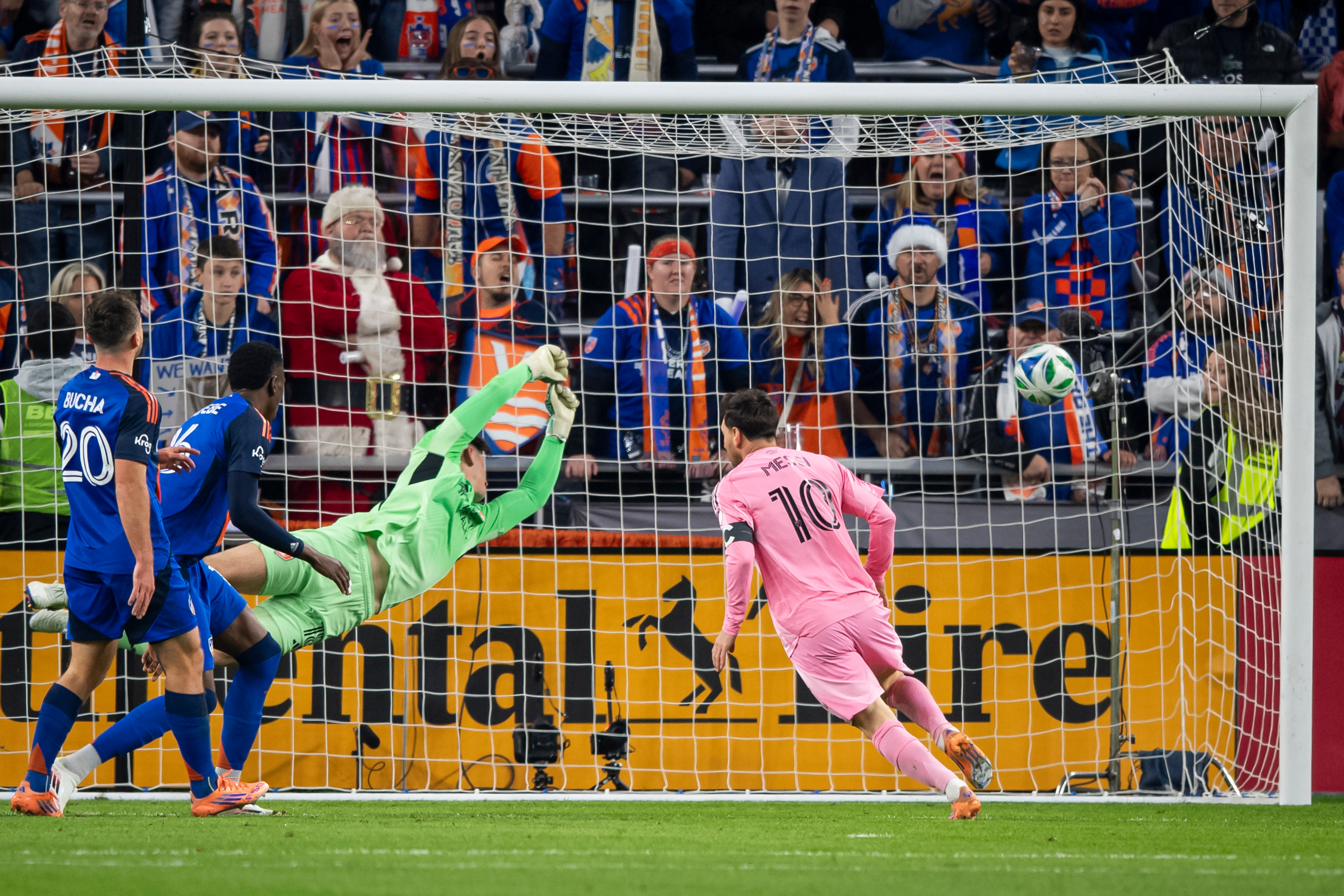 Inter Miami forward Lionel Messi (10) scores as FC Cincinnati goalkeeper Roman Celentano, third from left, tries to defend during the first half of MLS soccer's Eastern Conference semifinal Sunday, Nov. 23, 2025, in Cincinnati. 