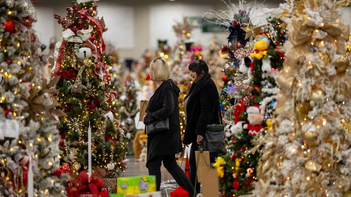 Two women walk in the Festival of Trees in Sandy on Dec. 3, 2024. This year, the Festival of Trees is taking place Dec. 3-6 at the Mountain American Expo Center in Sandy.