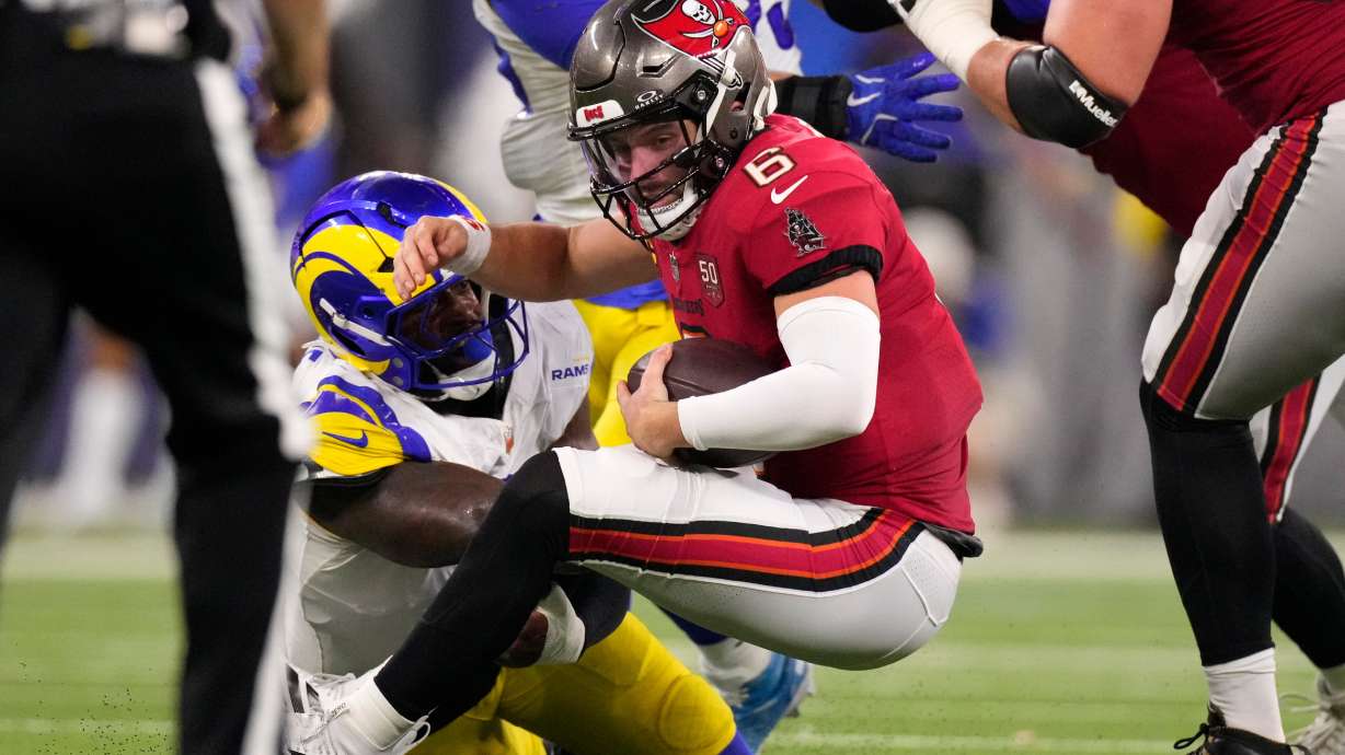 Los Angeles Rams linebacker Jared Verse tackles Tampa Bay Buccaneers quarterback Baker Mayfield during the first half of an NFL football game, Sunday, Nov. 23, 2025, in Inglewood, Calif.