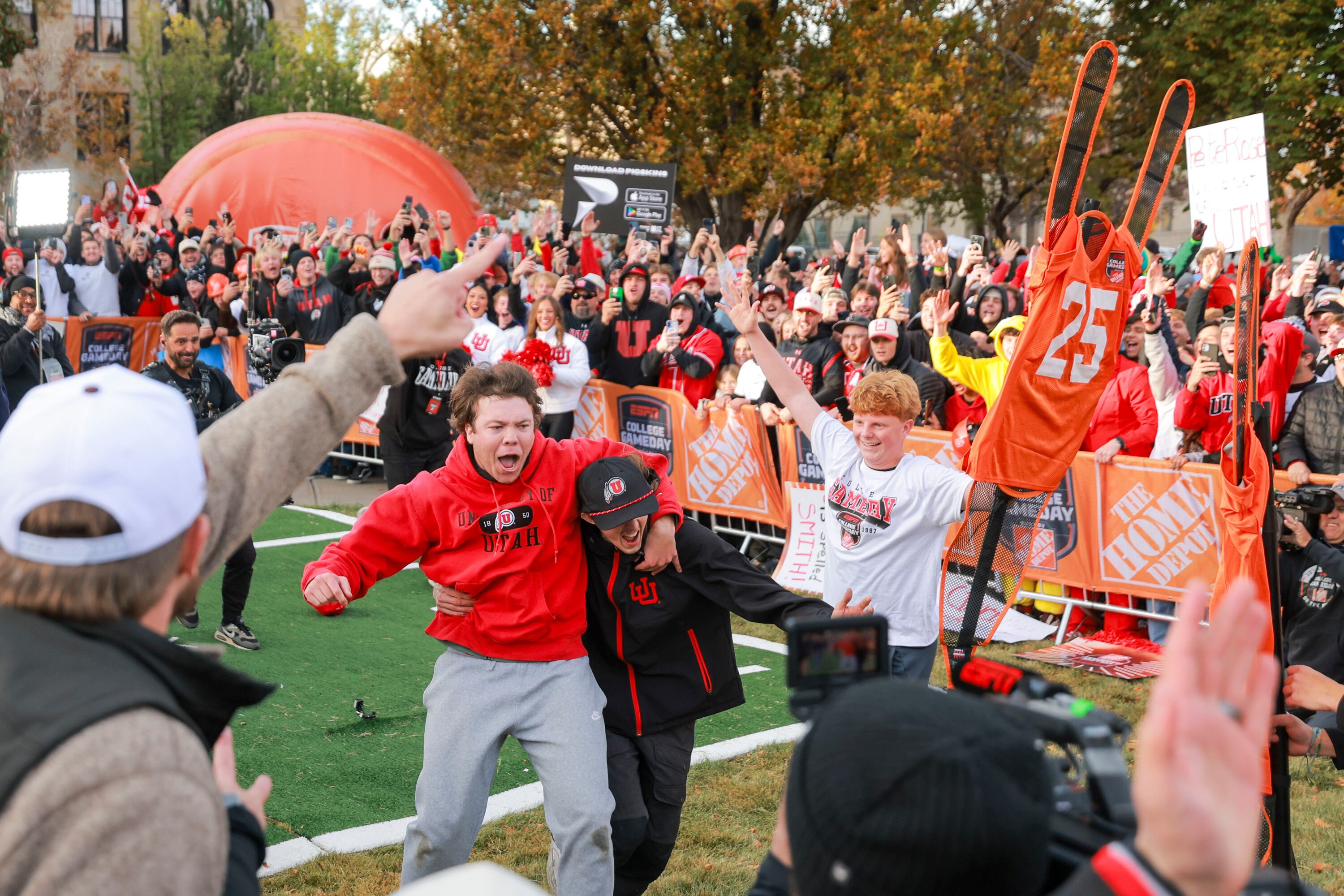Jonah Knubel, left, celebrates after making a field goal on his second attempt for Pat McAfee’s kicking contest during ESPN’s “College GameDay” in the Presidents Circle at the University of Utah in Salt Lake City on Nov. 1.