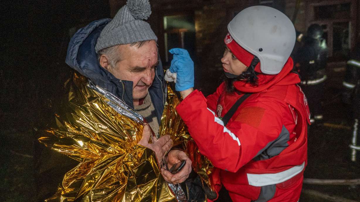 A paramedic gives first aid to a resident who was injured in a Russian airstrike in Kharkiv, Ukraine, late Sunday.