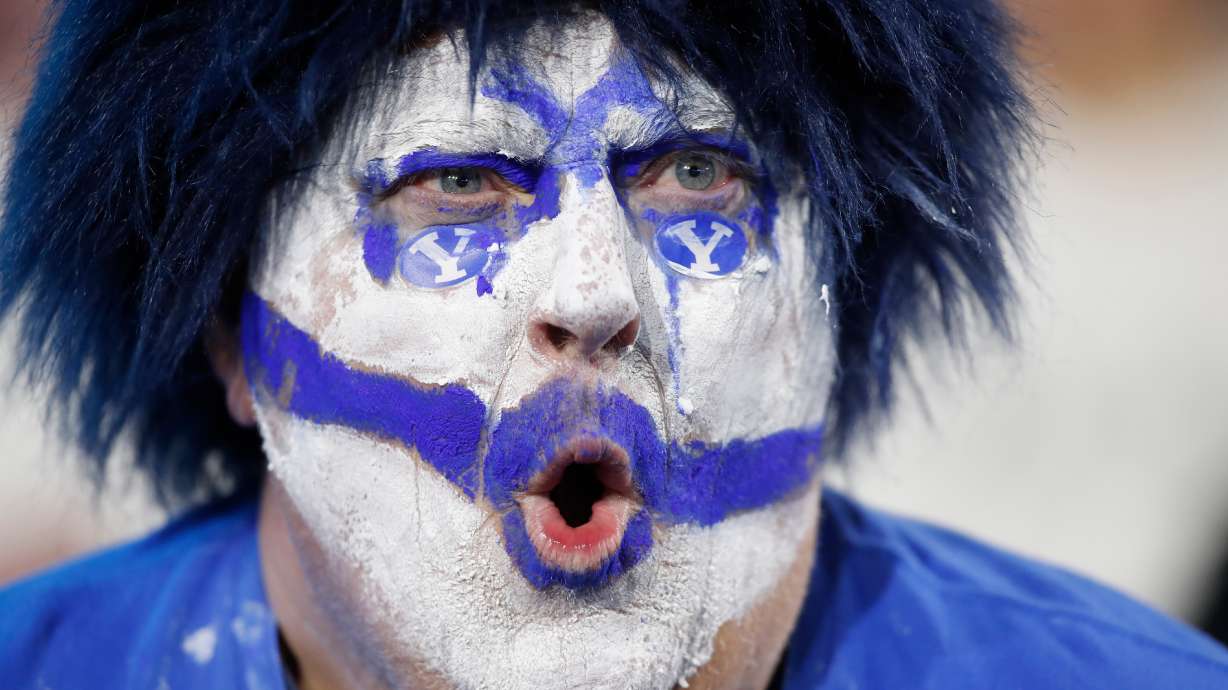 A BYU fan cheers during the second half of an NCAA college football game against TCU Saturday, Nov. 15, 2025, in Provo, Utah.