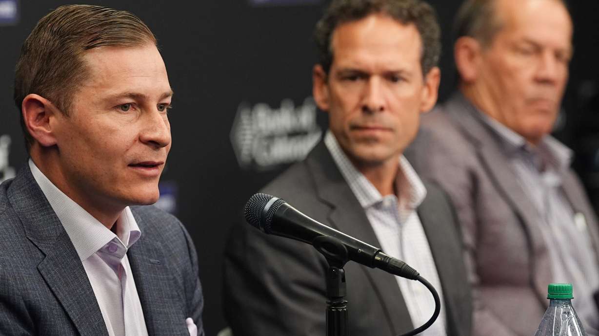 Walker Monfort, left, executive vice president of the Colorado Rockies, responds to a question as Paul DePodesta, the team's new president of baseball operations, center, and Dick Monfort, chairman and chief executive officer, look on during a news conference Thursday, Nov. 13, 2025, in Denver.