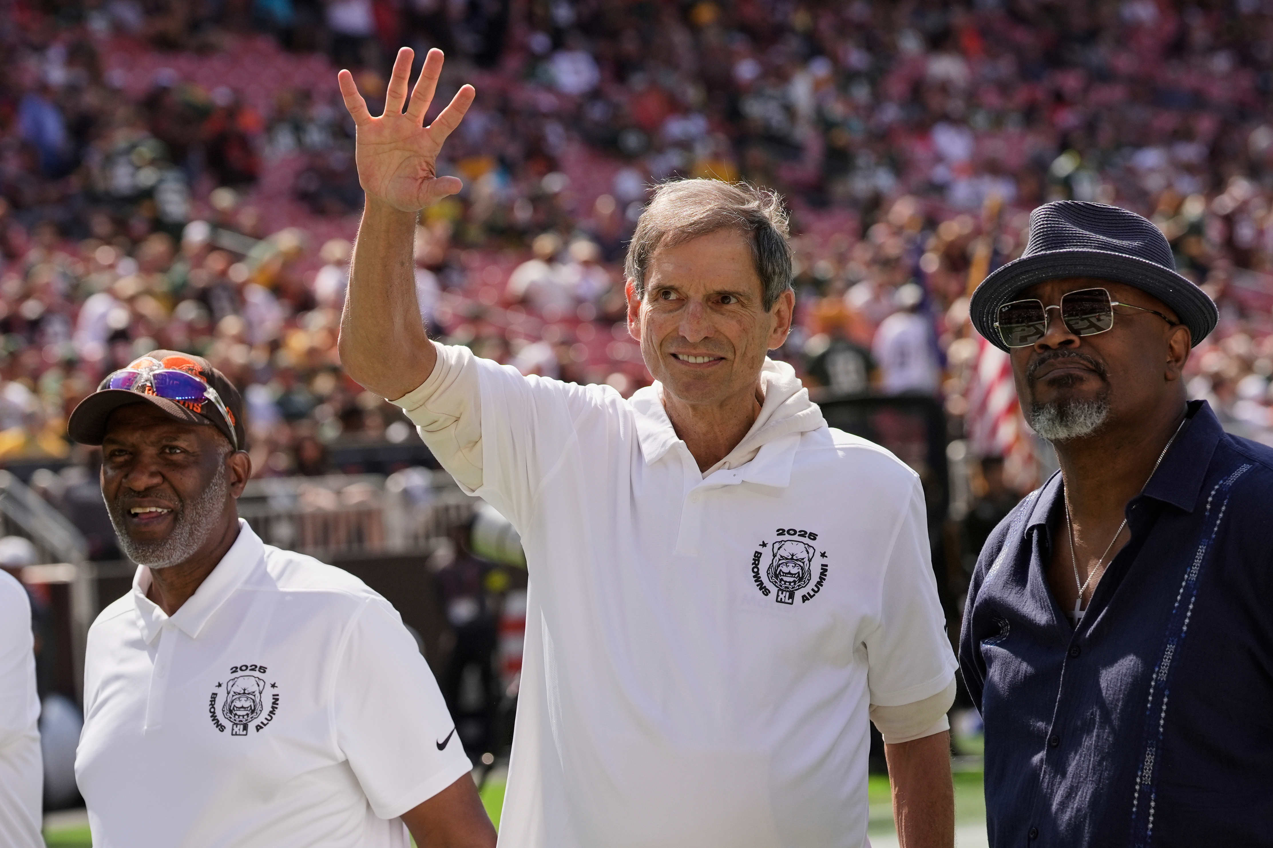 FILE - Former Cleveland Browns quarterback Bernie Kosar waves during a Browns' Alumni event before an NFL football game between the Green Bay Packers and the Cleveland Browns in Cleveland, Sunday, Sept. 21, 2025. 