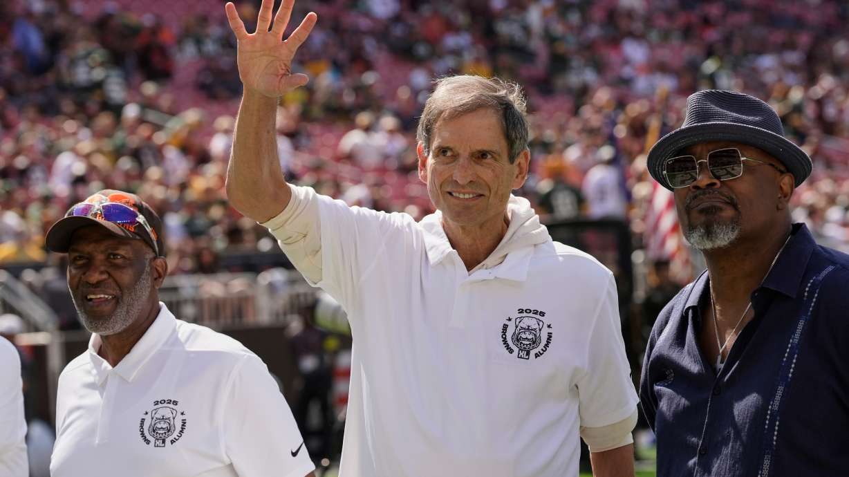 FILE - Former Cleveland Browns quarterback Bernie Kosar waves during a Browns' Alumni event before an NFL football game between the Green Bay Packers and the Cleveland Browns in Cleveland, Sunday, Sept. 21, 2025.