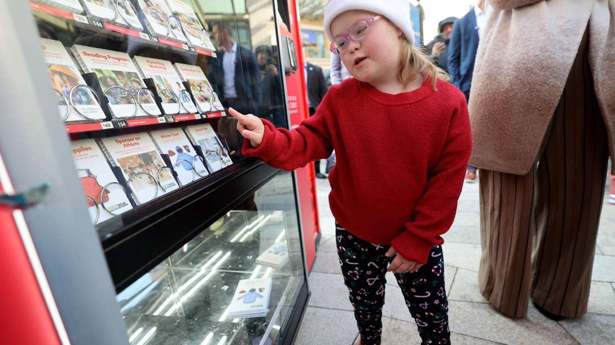 Ruby Wixom looks at a Light the World Giving Machine during a kickoff celebration at City Creek Center in Salt Lake City on Monday. Utah's 2025 Light the World Giving Machines officially opened.