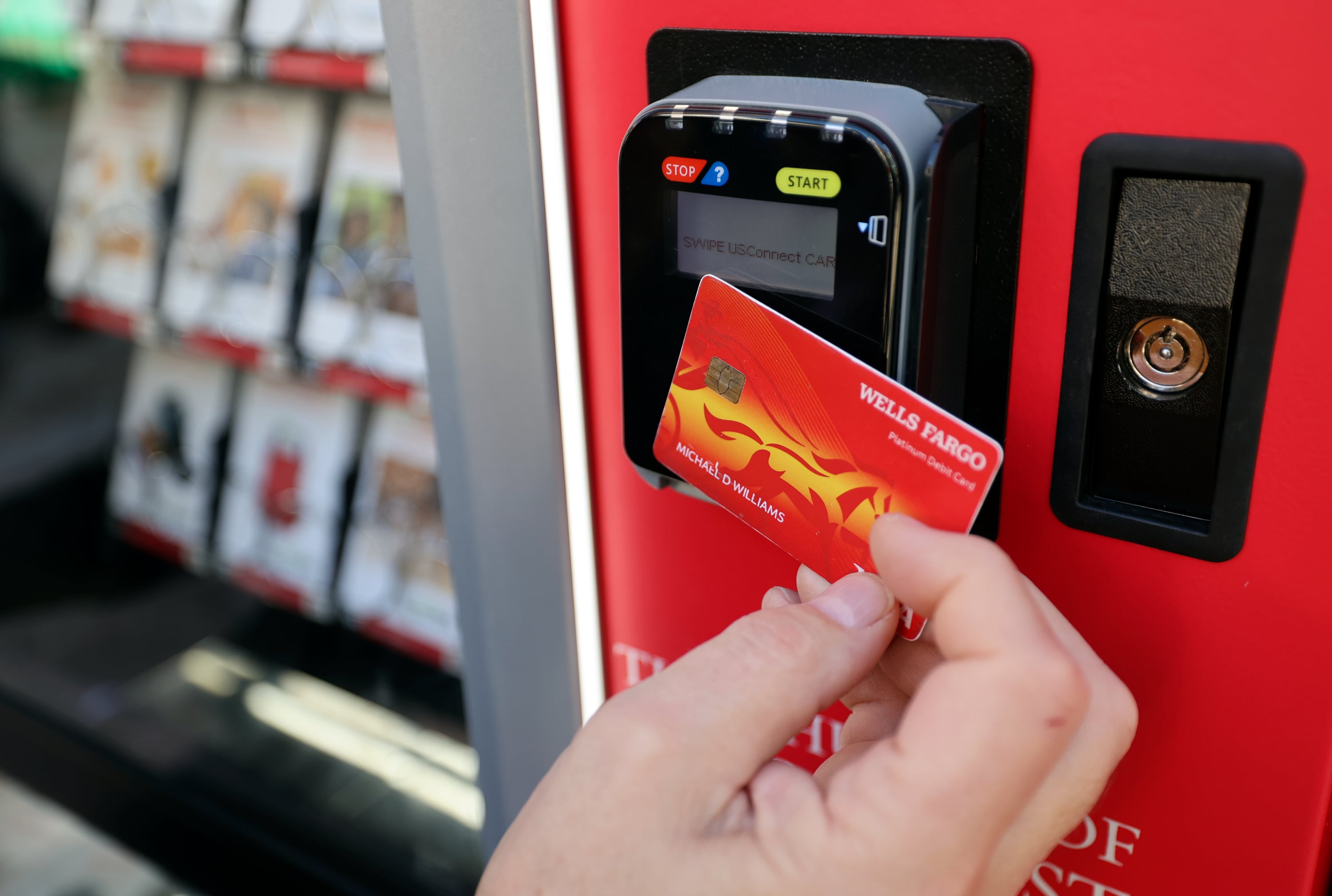 Mike Williams makes a donation at a Light the World Giving Machine at City Creek Center in Salt Lake City on Monday.