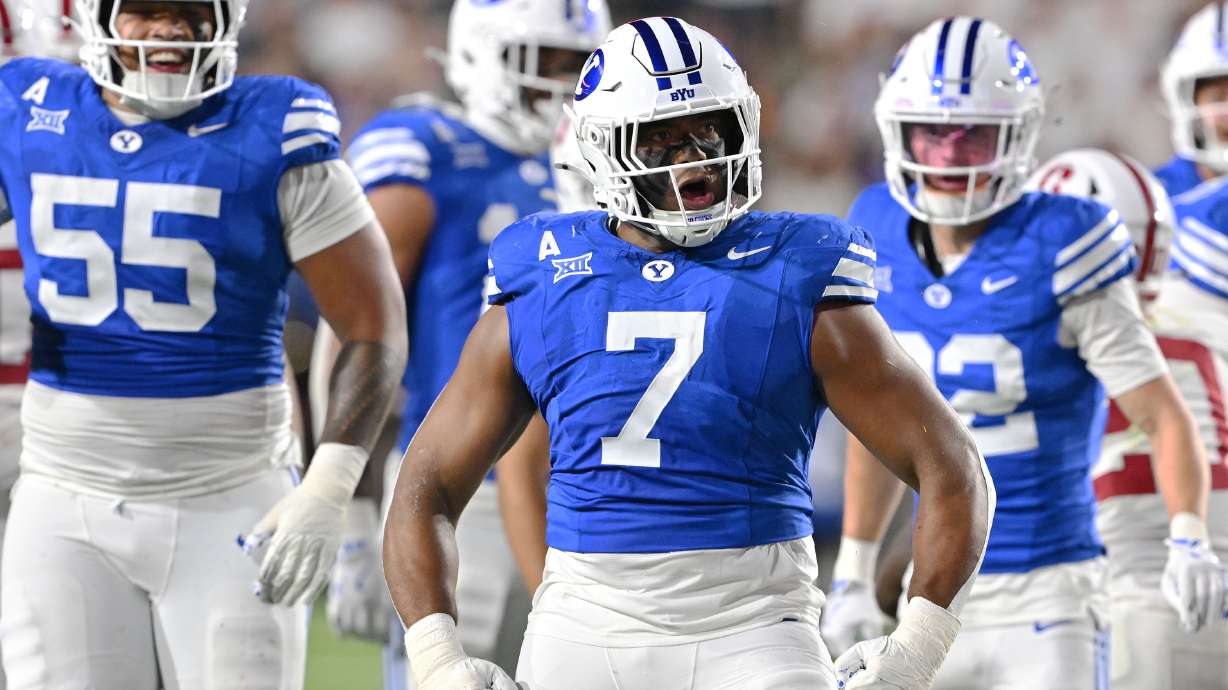 Brigham Young defensive end Logan Lutui (7) celebrates after a tackle for a loss as BYU and Stanford play in Provo on Saturday, Sept. 6, 2025. BYU won 27-3.