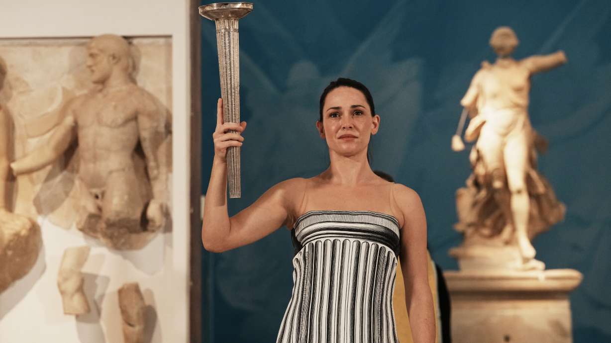 Actress Mary Mina playing the role of high priestess performs during the final rehearsal ahead of the flame lighting for the Milan Cortina 2026 Winter Olympics, at the archaeological museum of Olympia, Greece, Tuesday, Nov. 25, 2025.