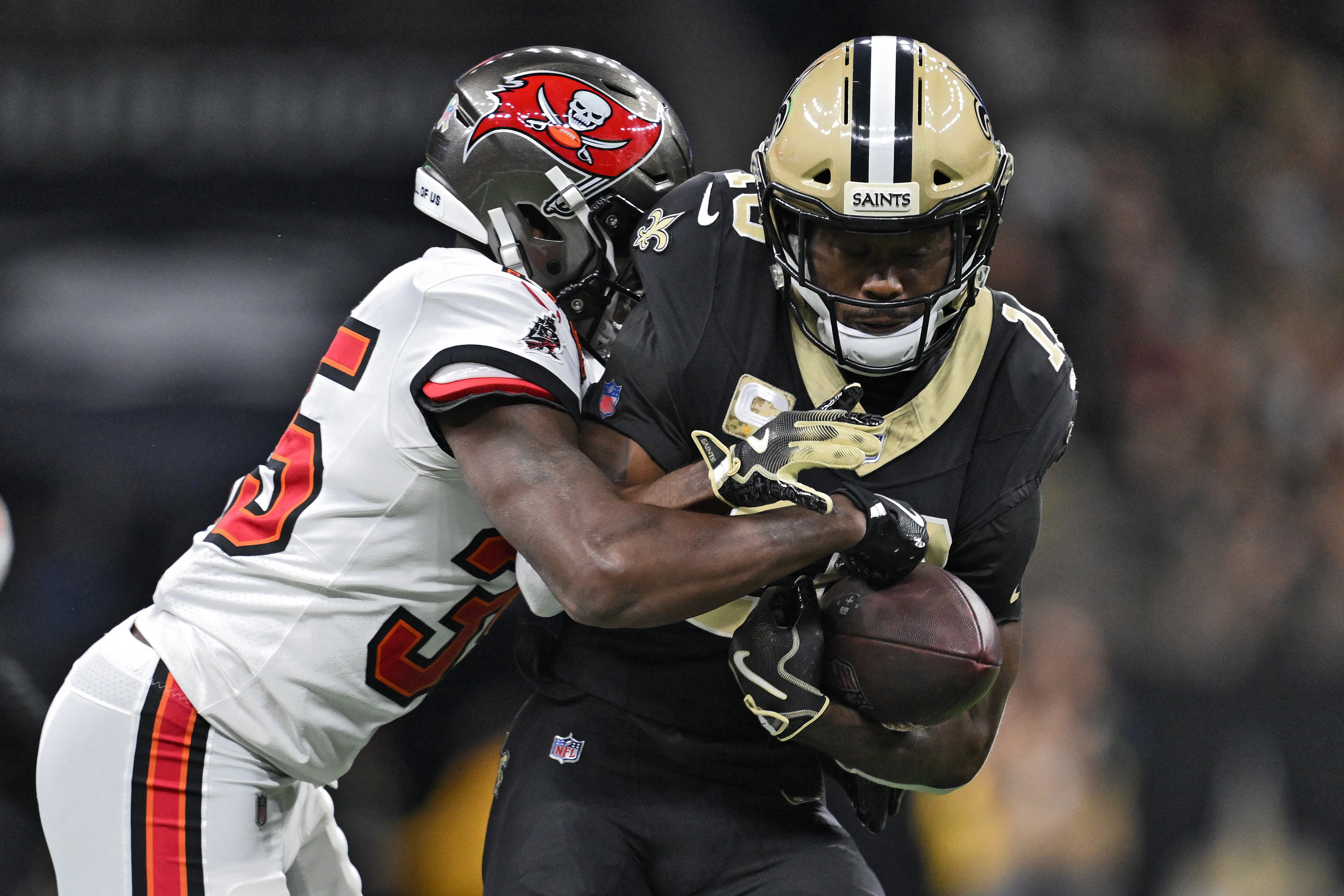 New Orleans Saints wide receiver Brandin Cooks (10) is stopped by Tampa Bay Buccaneers cornerback Jamel Dean (35) after a reception during the second half of an NFL football game Sunday, Oct. 26, 2025, in New Orleans. 