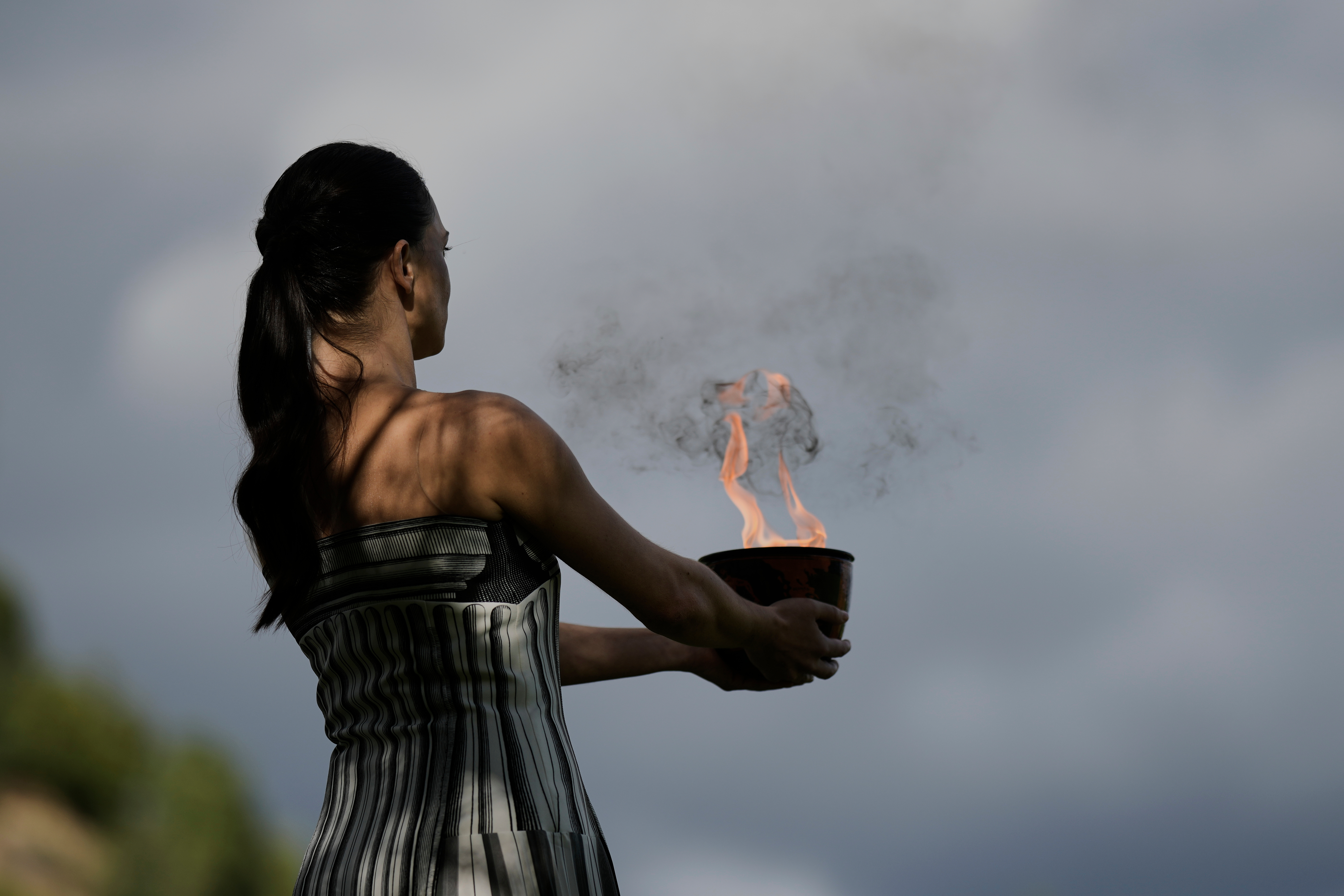 Under a cloud, the Olympic flame begins its journey to the Milan Cortina Winter Olympics