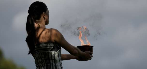 Under a cloud, the Olympic flame begins its journey to the Milan Cortina Winter Olympics