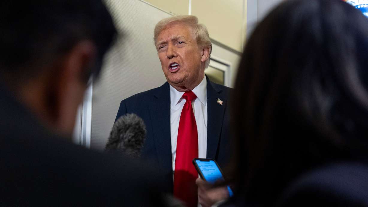 President Donald Trump speaks with reporters while in flight on Air Force One from Joint Base Andrews to his Mar-a-Lago estate in Palm Beach, Fla., Tuesday. Prosecutor drops election interference case in Georgia against Trump and others.