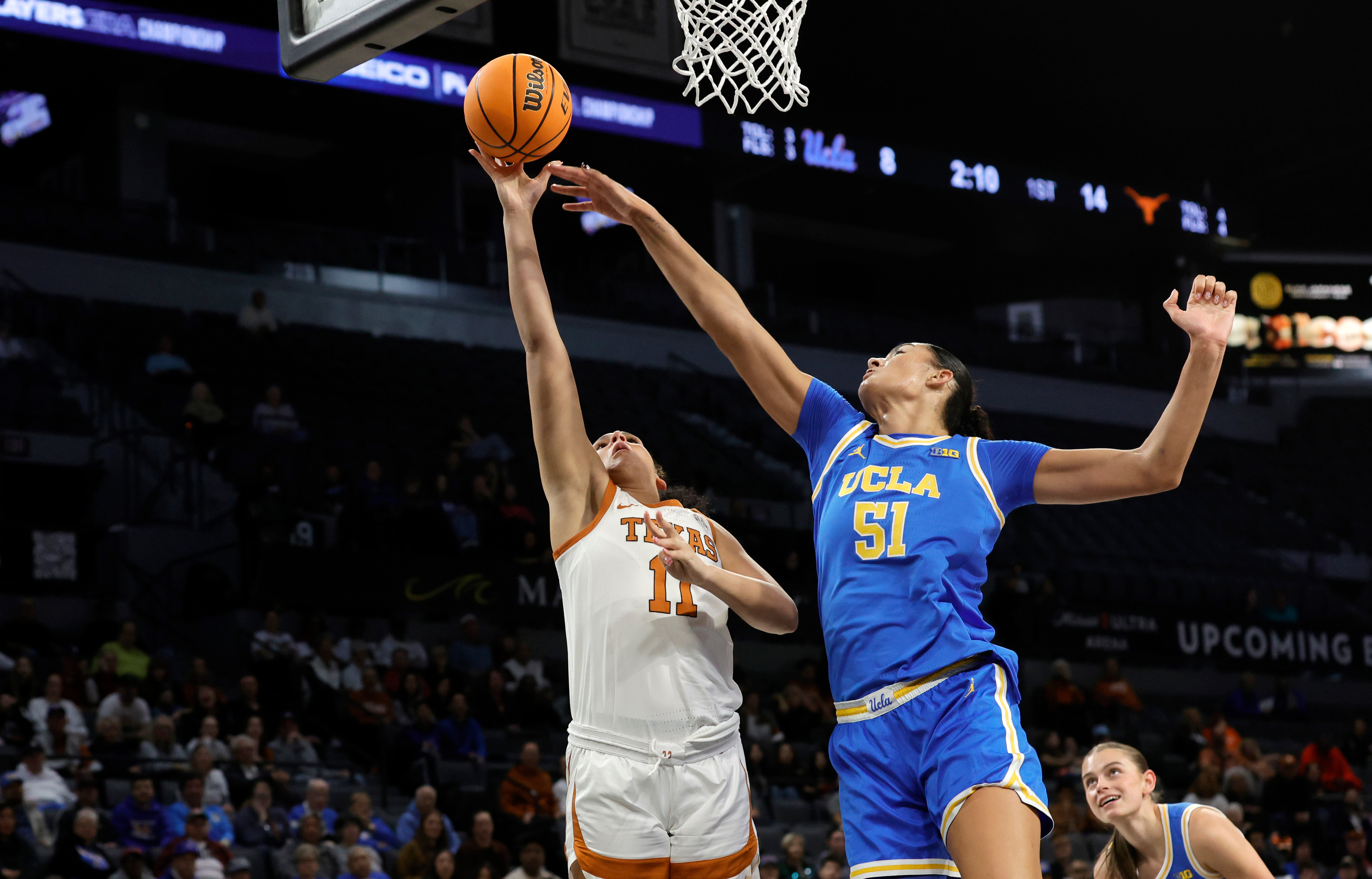 Texas forward Justice Carlton (11) shoots a layup against UCLA center Lauren Betts (51) during the first half of an NCAA college basketball game in the Players Era tournament Wednesday, Nov. 26, 2025, in Las Vegas. 