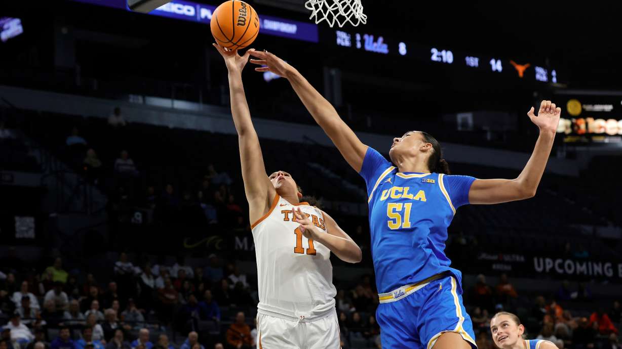 Texas forward Justice Carlton (11) shoots a layup against UCLA center Lauren Betts (51) during the first half of an NCAA college basketball game in the Players Era tournament Wednesday, Nov. 26, 2025, in Las Vegas.