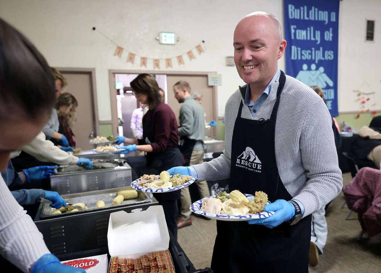 Gov. Spencer Cox serves food at the annual Thanksgiving banquet at the Rescue Mission in Salt Lake City on Wednesday.