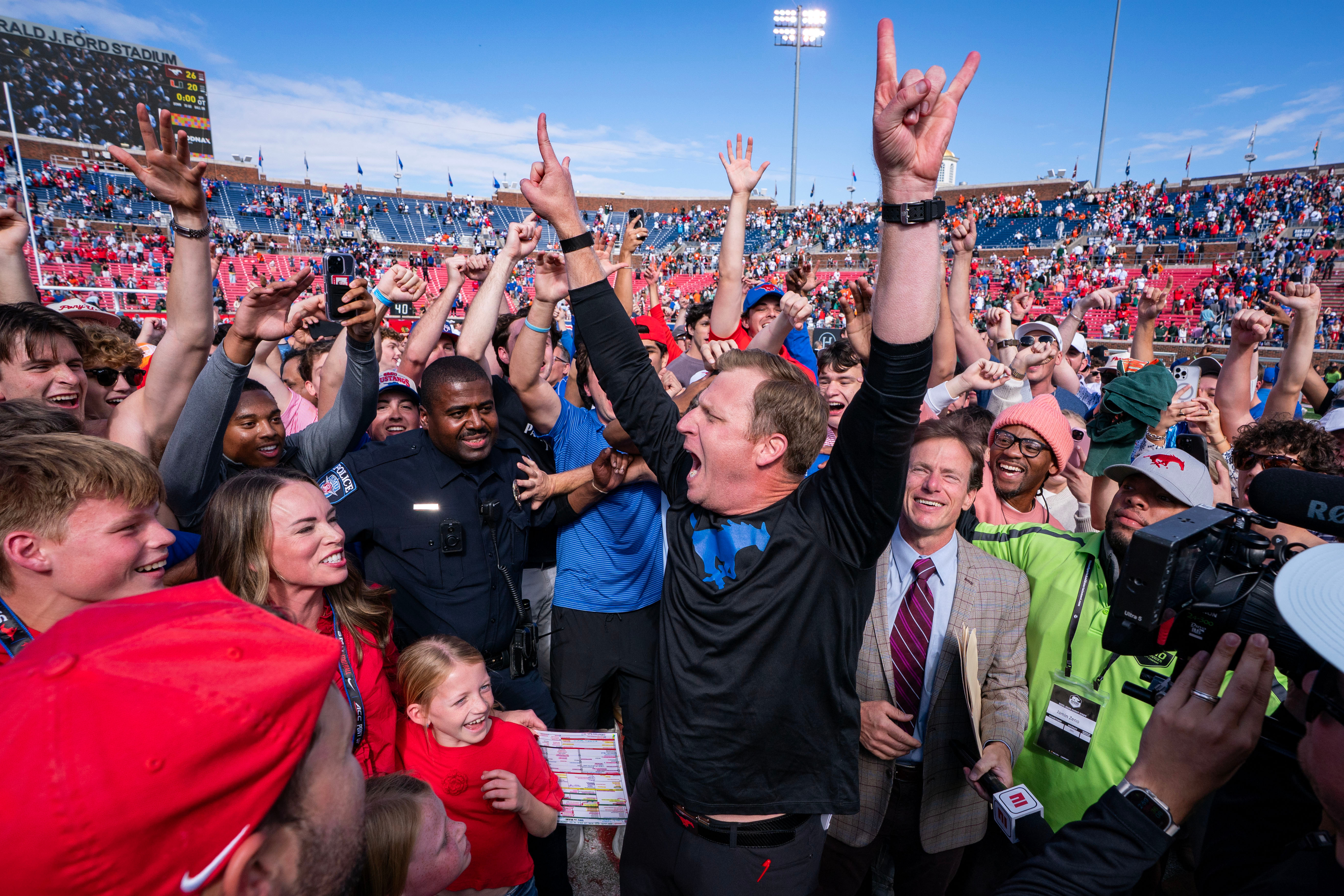SMU head coach Rhett Lashlee celebrates on the field with fans after his team's 26-20 overtime win over Miami in an NCAA college football game, Saturday, Nov. 1, 2025, in Dallas. 