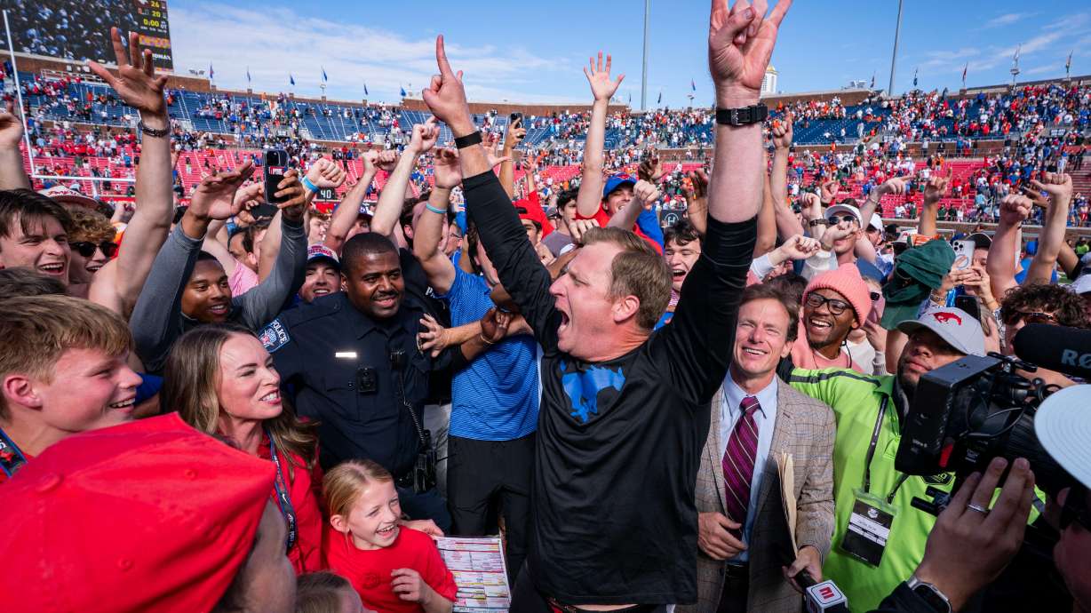 SMU head coach Rhett Lashlee celebrates on the field with fans after his team's 26-20 overtime win over Miami in an NCAA college football game, Saturday, Nov. 1, 2025, in Dallas.