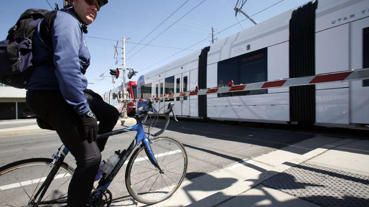 Ken Bohney waits for a train to pass through a railroad crossing in Salt Lake City on April 16, 2012. Initial information collected as part of a study of Salt Lake City's east-west transportation divide underscores the challenges that exist in Utah's capital city.