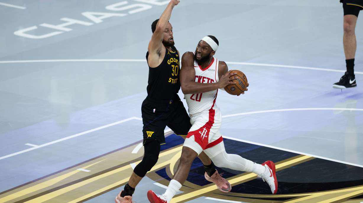 Houston Rockets guard Josh Okogie is guarded by Golden State Warriors guard Stephen Curry during the first half of an Emirates NBA Cup basketball game Wednesday, Nov. 26, 2025, in San Francisco.