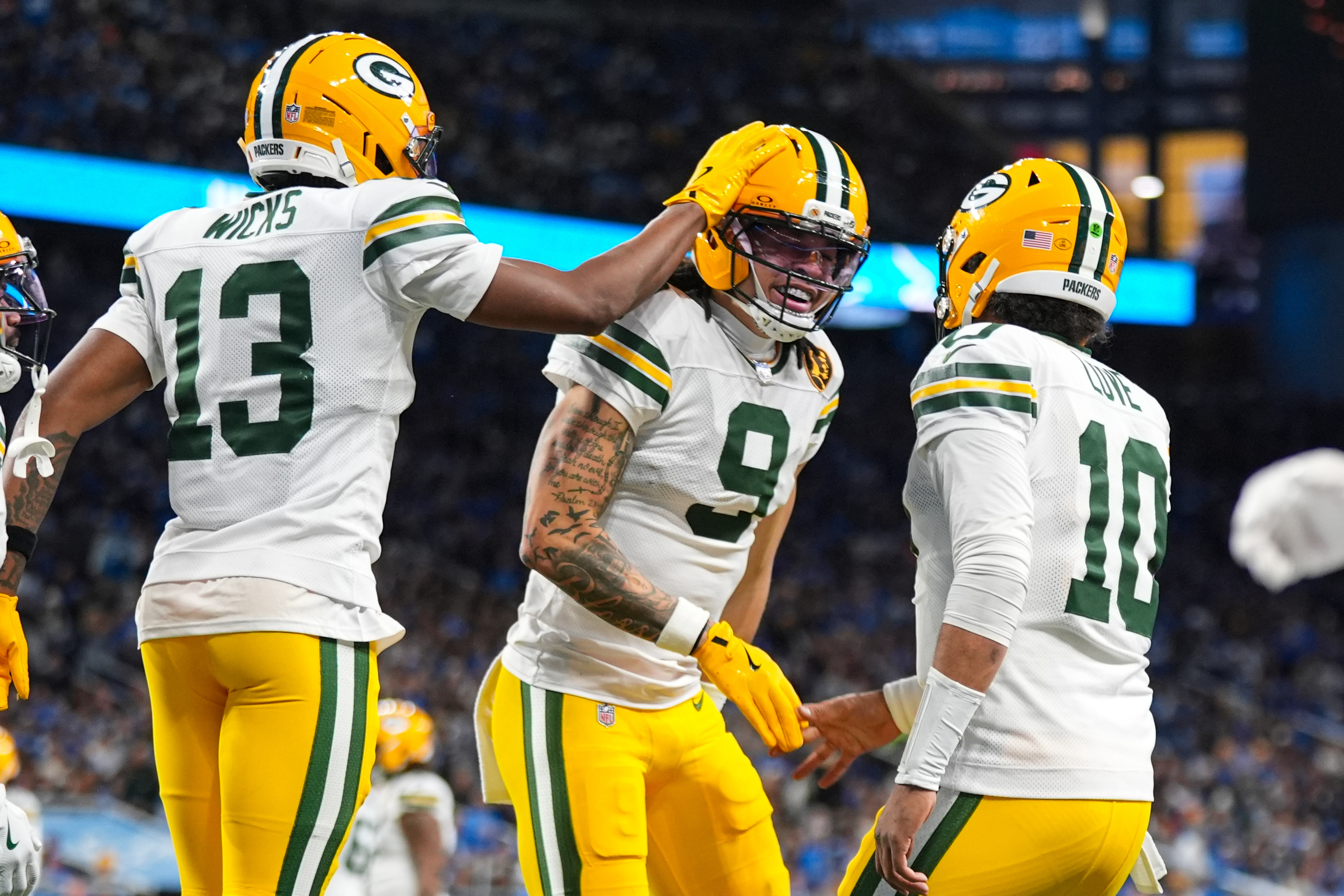 Green Bay Packers wide receiver Christian Watson (9) celebrates a touchdown with wide receiver Dontayvion Wicks (13) and quarterback Jordan Love (10) against the Detroit Lions during the second half an NFL football game in Detroit, Thursday, Nov. 27, 2025. 