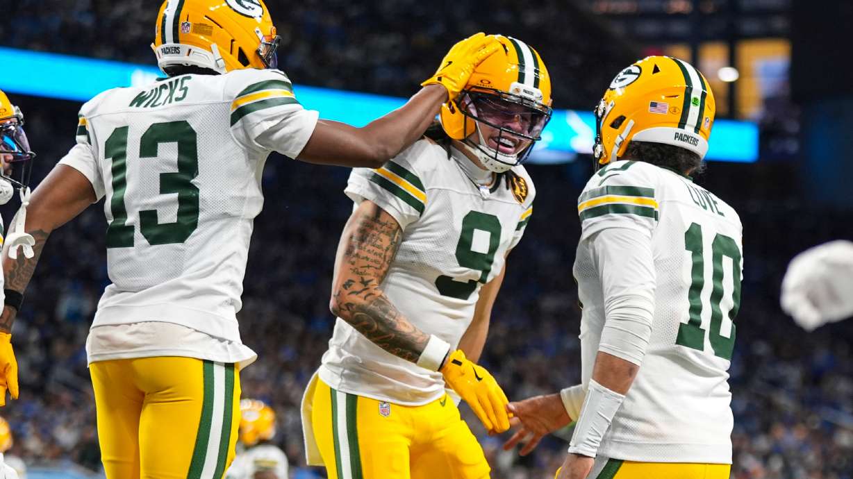 Green Bay Packers wide receiver Christian Watson (9) celebrates a touchdown with wide receiver Dontayvion Wicks (13) and quarterback Jordan Love (10) against the Detroit Lions during the second half an NFL football game in Detroit, Thursday, Nov. 27, 2025.