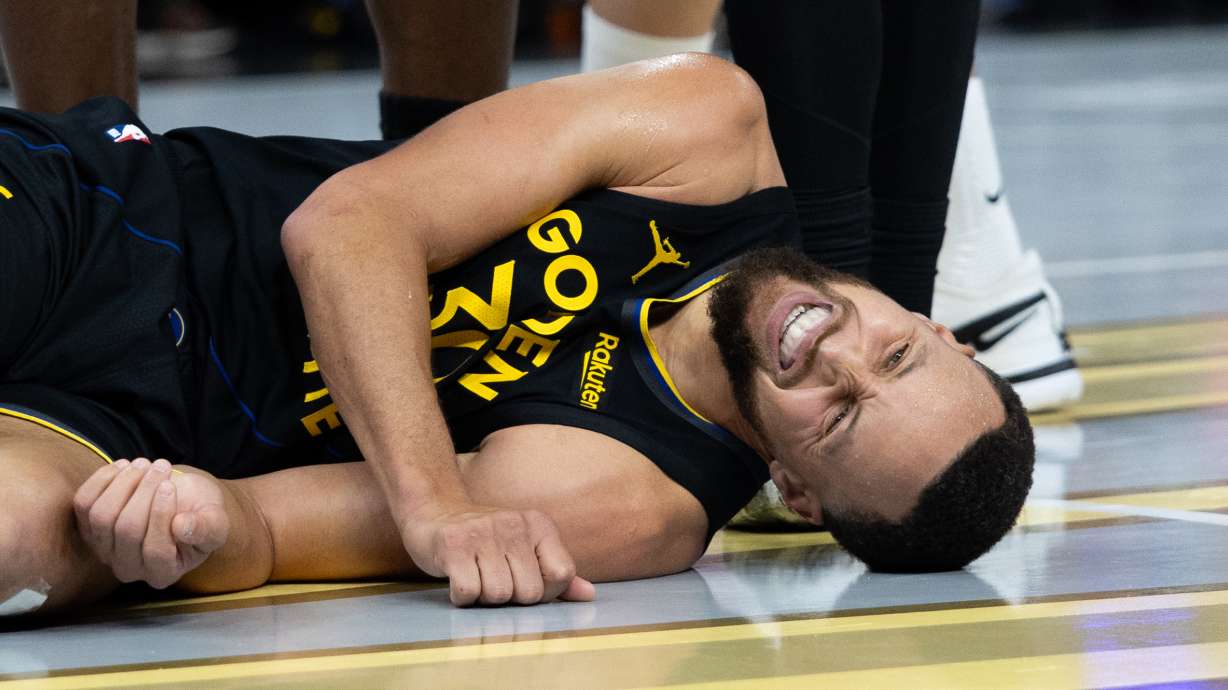 Golden State Warriors guard Stephen Curry lies on the floor during the second half of an Emirates NBA Cup basketball game against the Houston Rockets Wednesday, Nov. 26, 2025, in San Francisco.