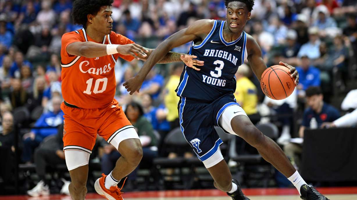 BYU forward AJ Dybantsa (3) drives against Miami guard Tru Washington (10) during the first half of an NCAA college basketball game, Thursday, Nov. 27, 2025, in Kissimmee, Fla.