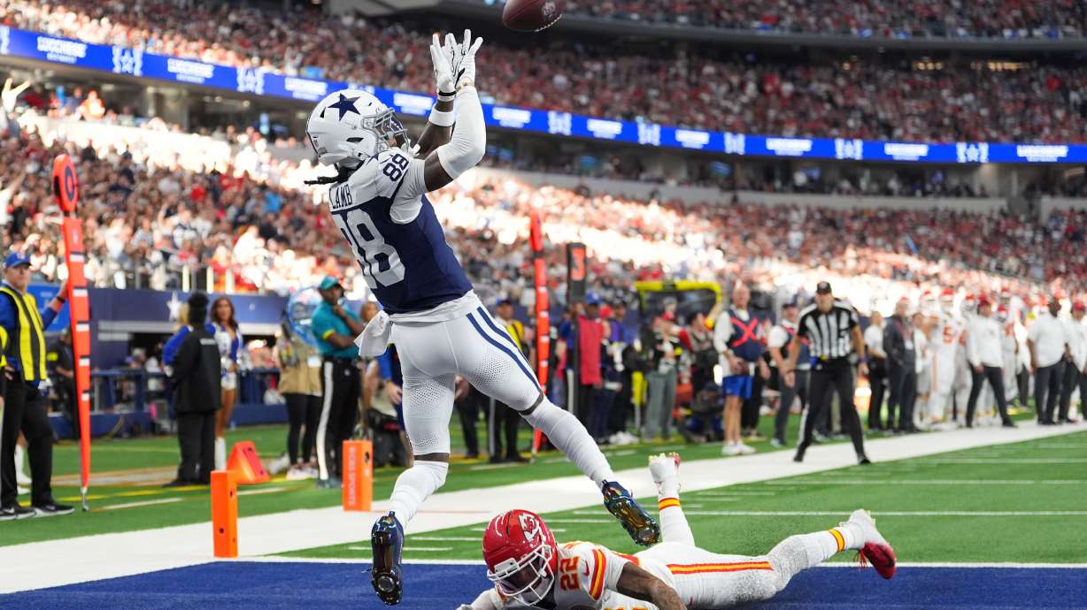 Dallas Cowboys wide receiver CeeDee Lamb (88) catches a touchdown pass as Kansas City Chiefs cornerback Trent McDuffie (22) defends during the first half of an NFL football game Thursday, Nov. 27, 2025, in Arlington, Texas.