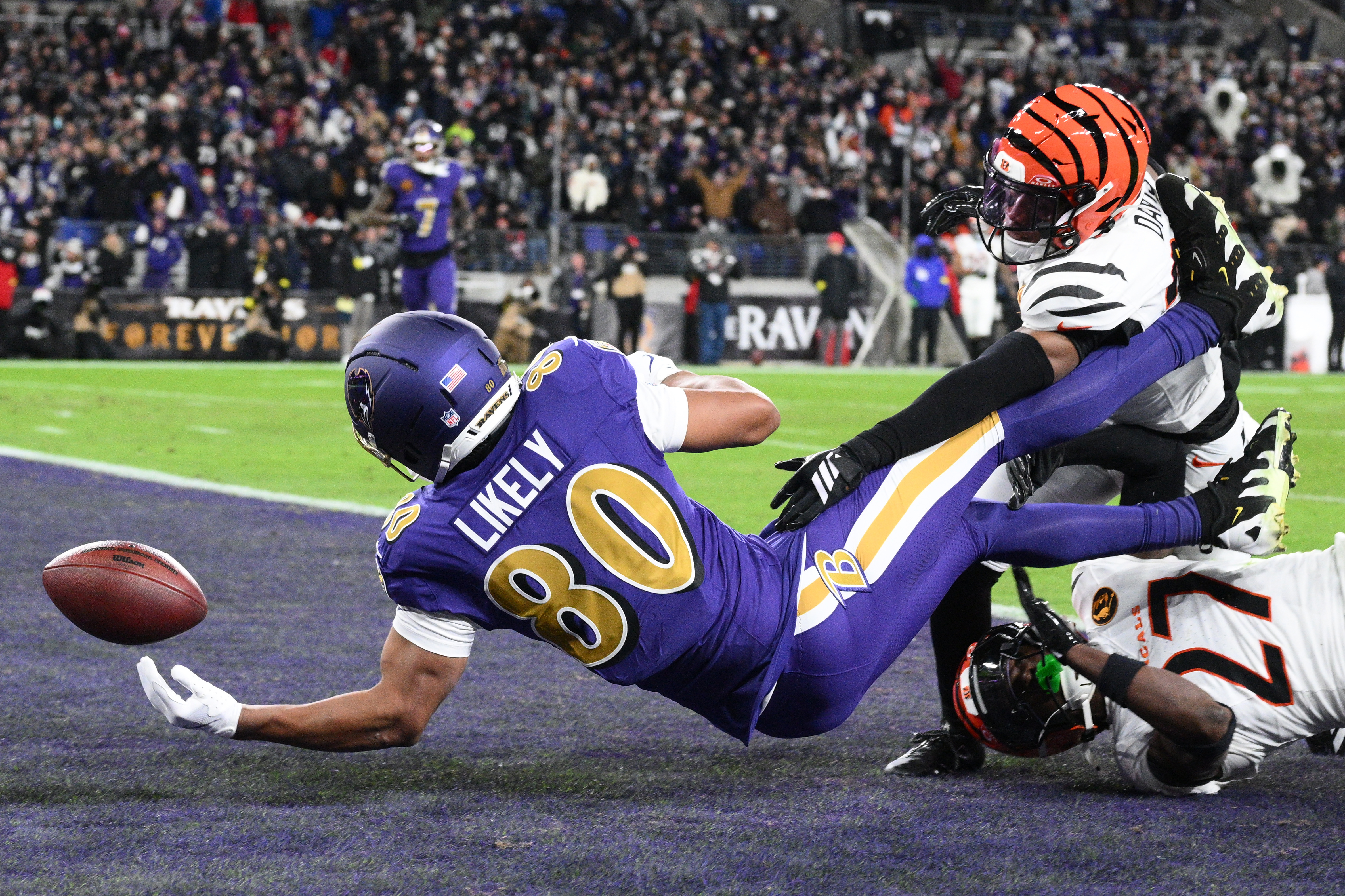 Baltimore Ravens tight end Isaiah Likely (80) fumbles the ball in the end zone as Cincinnati Bengals cornerback Jalen Davis (35) and Cincinnati Bengals safety Jordan Battle (27) defend during the first half of an NFL football game, Thursday, Nov. 27, 2025, in Baltimore.
