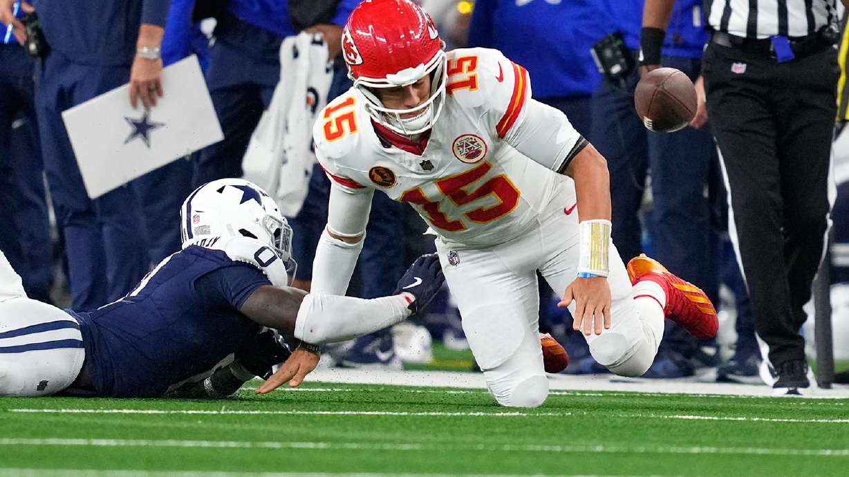 Dallas Cowboys linebacker DeMarvion Overshown, left, knocks the ball out of bounds away from Kansas City Chiefs quarterback Patrick Mahomes during the first half of an NFL football game Thursday, Nov. 27, 2025, in Arlington, Texas.