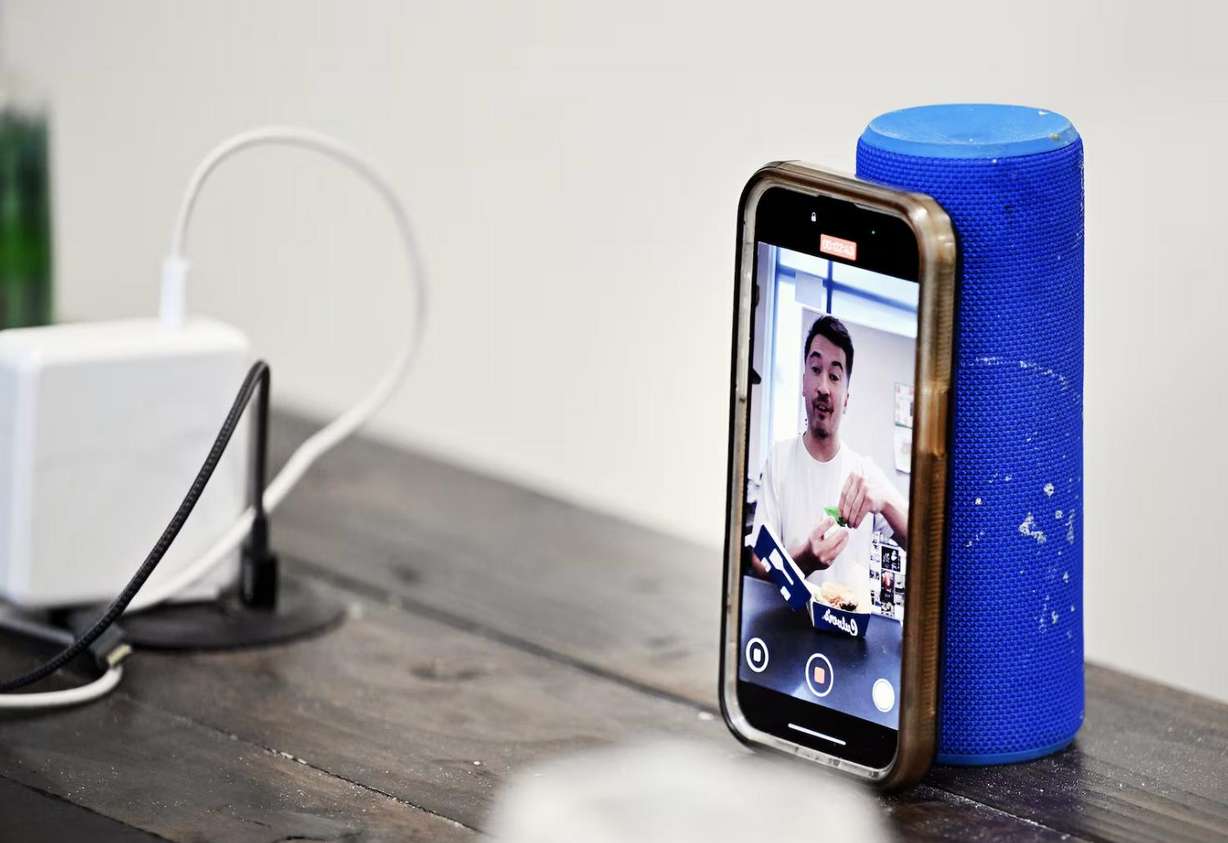 Lehi High School social studies teacher Joey Hall records a video while on a lunch break at school in Lehi on Nov. 18. Hall has amassed 2.2 million followers on TikTok doing food reviews.