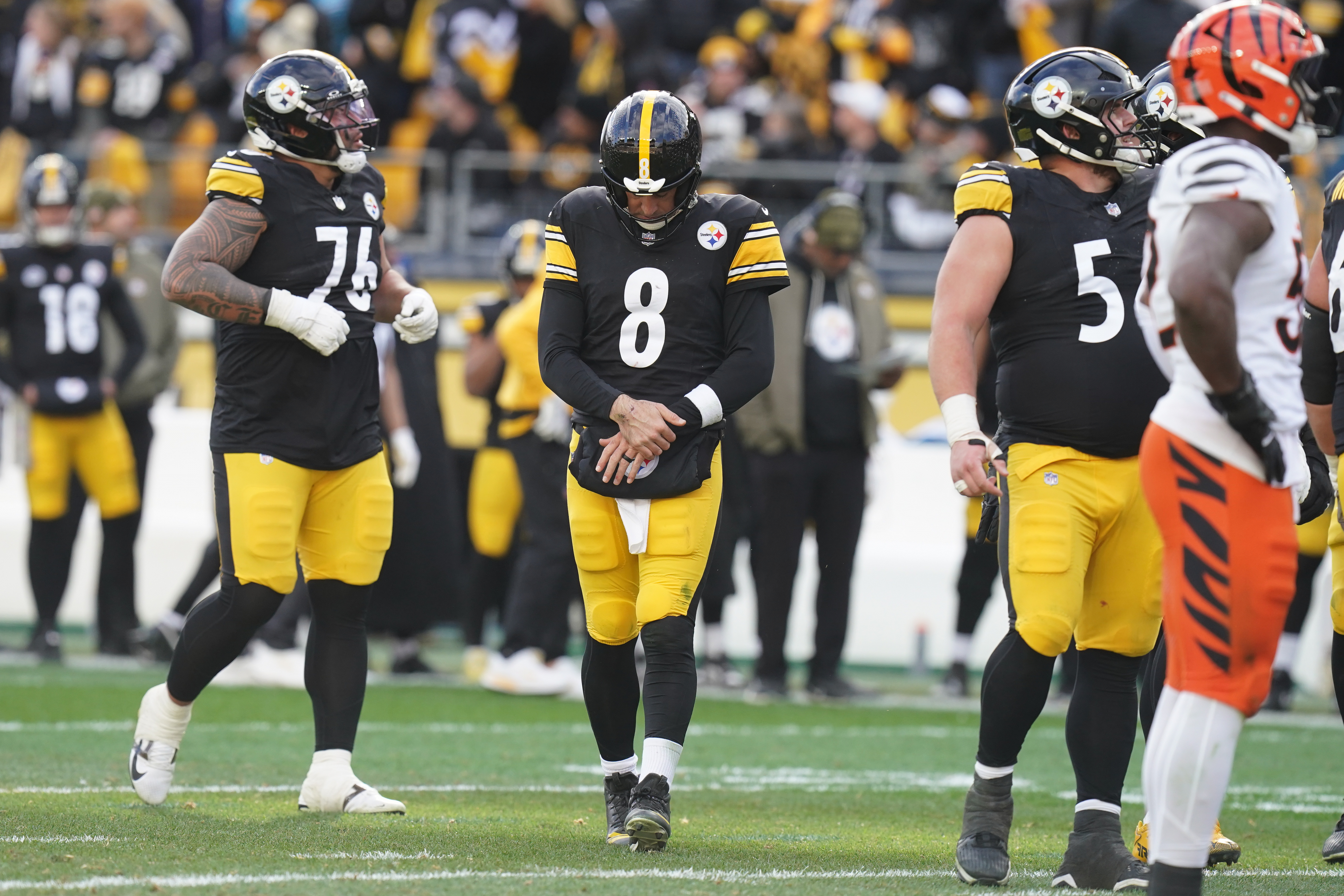 Pittsburgh Steelers quarterback Aaron Rodgers (8) holds his arm after a hit by the Cincinnati Bengals during the first half of an NFL football game Sunday, Nov. 16, 2025, in Pittsburgh. 