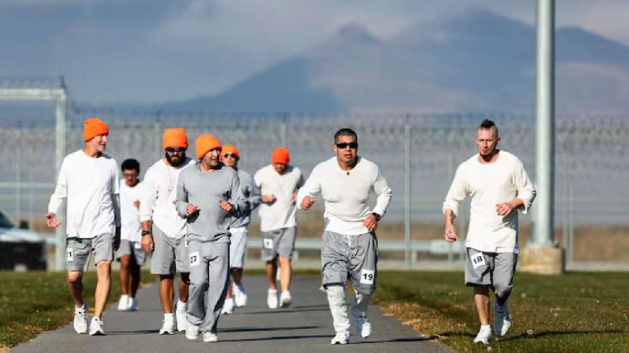 From right, Drew Campbell and Jose Diaz run with other incarcerated individuals during the Fit From Within marathon, held at an exercise yard within the Utah State Correctional Facility in Salt Lake City on Nov. 21.