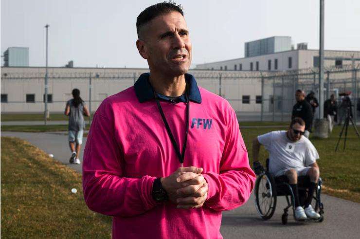 Casey Vanderhoef is interviewed by a member of the media during the Fit From Within marathon, held at an exercise yard within the Utah State Correctional Facility in Salt Lake City on Nov. 21.