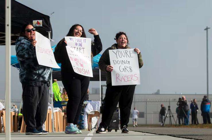 From left, Heather Singleton, Britney Nuñez and Taylor Albrecht, all with Utah’s Division of Correctional Health Services, cheer on incarcerated individuals during the Fit From Within marathon, held at an exercise yard within the Utah State Correctional Facility in Salt Lake City on Nov. 21.