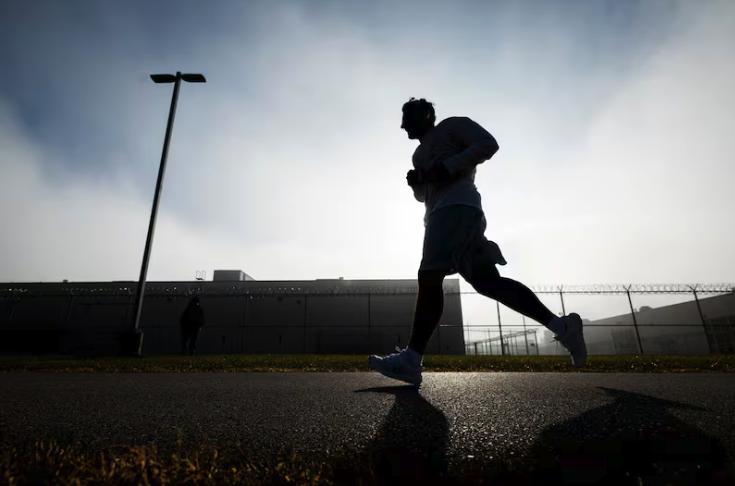 An incarcerated individual runs during the Fit From Within marathon, held at an exercise yard within the Utah State Correctional Facility in Salt Lake City on Nov. 21.