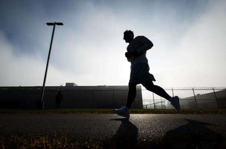 An incarcerated individual runs during the Fit From Within marathon, held at an exercise yard within the Utah State Correctional Facility in Salt Lake City on Nov. 21.